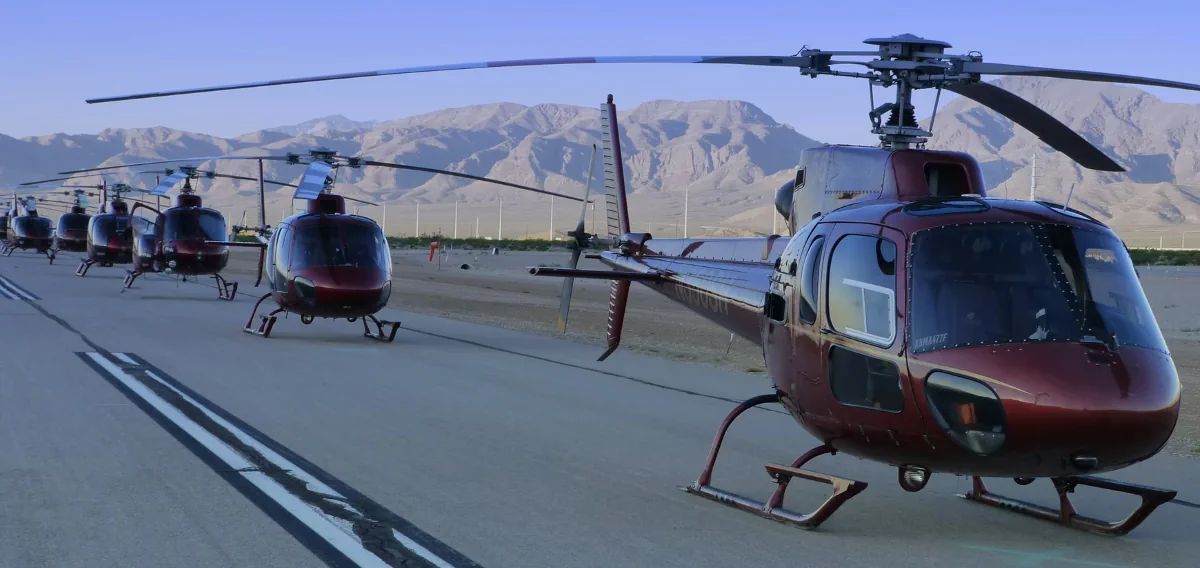A line of helicopters on a runway
