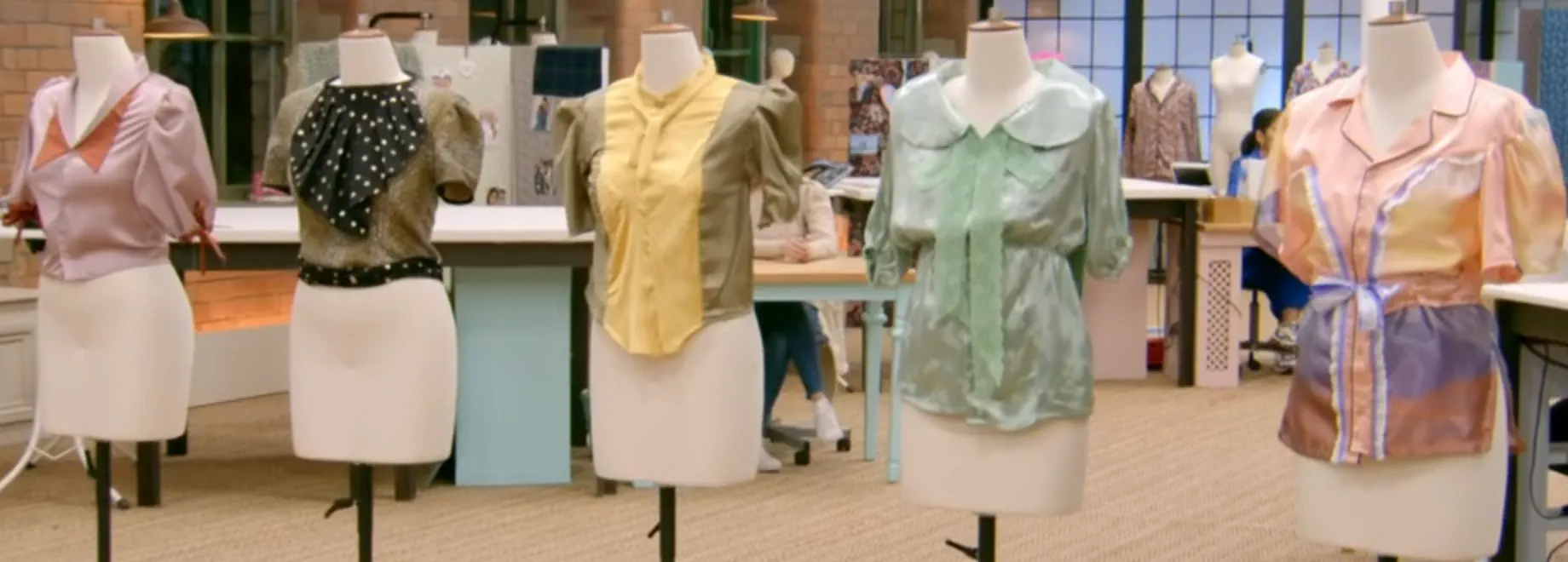 Five 1930s style women's blouses on mannequins, created by upcycling men's shirts