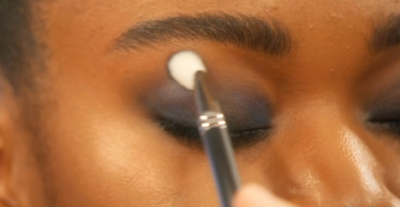 MUA softening the edges with a blending brush